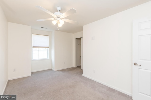 unfurnished room featuring ceiling fan and light colored carpet