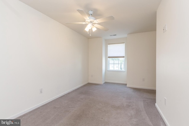 carpeted spare room with ceiling fan