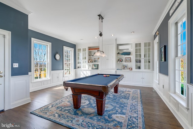 recreation room featuring built in shelves, dark hardwood / wood-style flooring, billiards, a wall unit AC, and ornamental molding