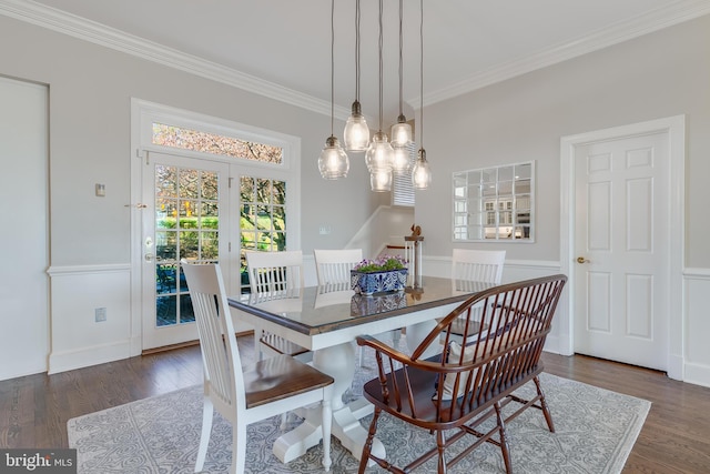 dining area with ornamental molding and dark wood-type flooring