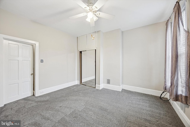 unfurnished bedroom featuring carpet flooring, ceiling fan, and a closet