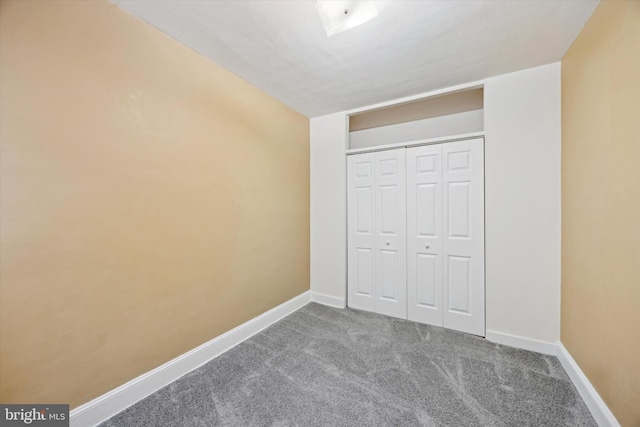 unfurnished bedroom featuring a closet and carpet