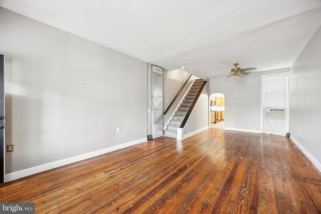 unfurnished living room featuring ceiling fan, cooling unit, and wood-type flooring