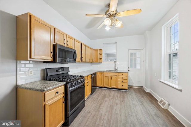 kitchen featuring ceiling fan, sink, light hardwood / wood-style flooring, backsplash, and black appliances