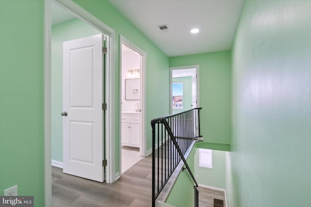 corridor with light hardwood / wood-style flooring and plenty of natural light