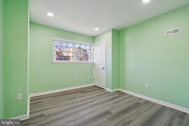 empty room with hardwood / wood-style flooring