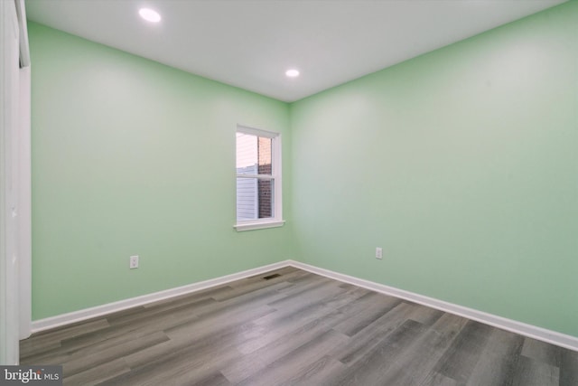 empty room with hardwood / wood-style flooring