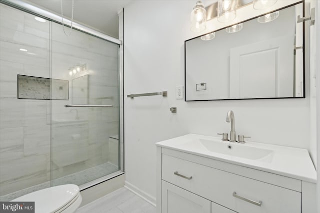 bathroom featuring vanity, toilet, and walk in shower