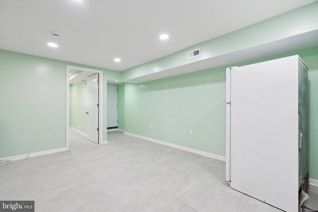 basement with white fridge