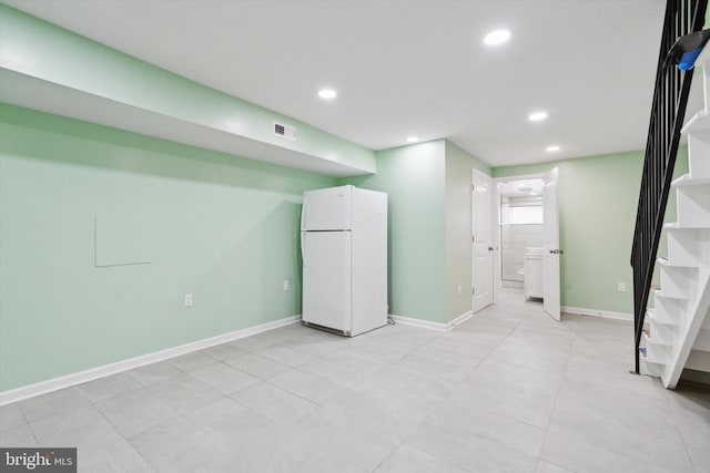 basement with white fridge