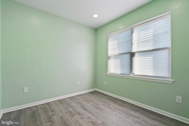 unfurnished room with hardwood / wood-style floors