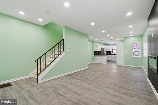 unfurnished living room featuring light hardwood / wood-style flooring