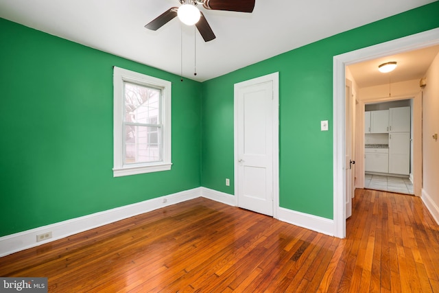 unfurnished bedroom featuring a closet, ceiling fan, and hardwood / wood-style floors