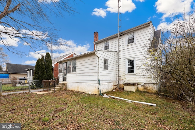 rear view of house with a yard