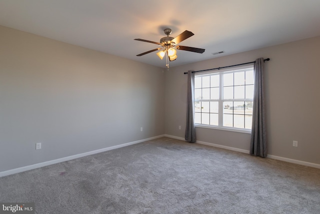 carpeted spare room featuring ceiling fan