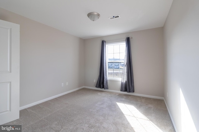 unfurnished room with light colored carpet