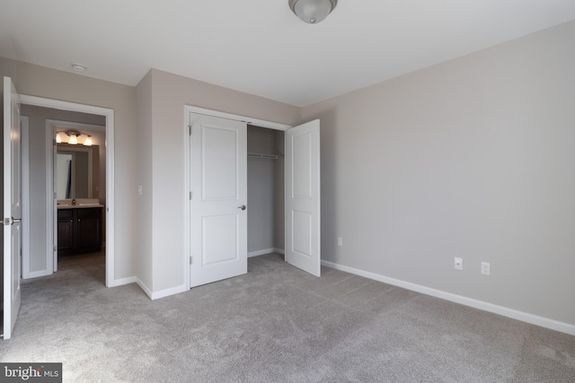 unfurnished bedroom featuring light carpet and a closet