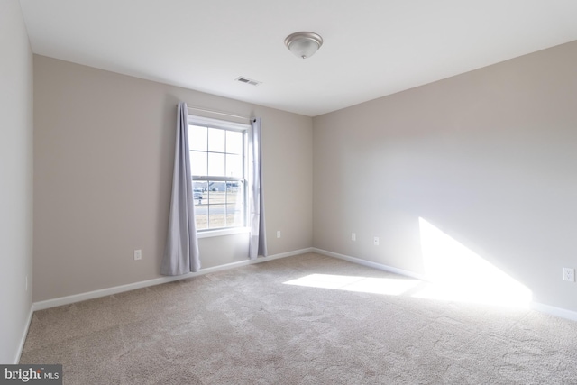 empty room featuring light carpet