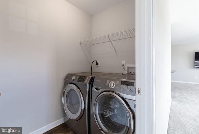 washroom with washing machine and dryer and carpet floors