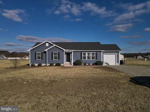 ranch-style house featuring a yard and a garage