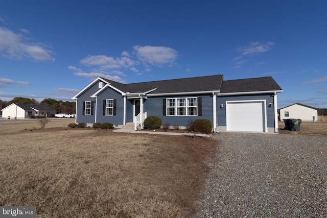 ranch-style house featuring a front yard and a garage