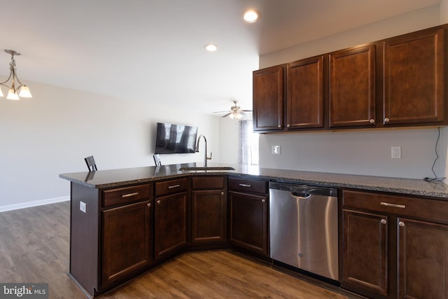 kitchen with dishwasher, ceiling fan with notable chandelier, sink, dark hardwood / wood-style flooring, and kitchen peninsula