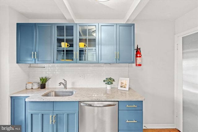 bar featuring sink, backsplash, stainless steel dishwasher, and blue cabinetry