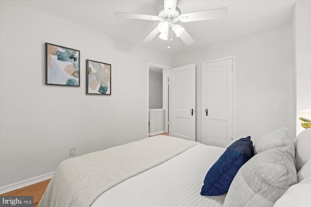 bedroom with ceiling fan and hardwood / wood-style floors