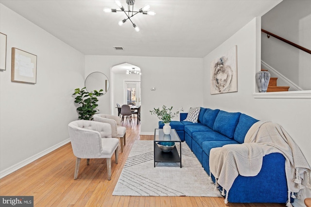 living room featuring hardwood / wood-style flooring and a chandelier