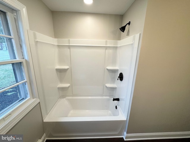 bathroom featuring a healthy amount of sunlight and shower / bathtub combination