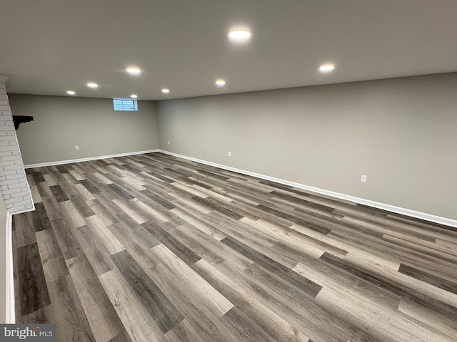 basement with dark hardwood / wood-style flooring