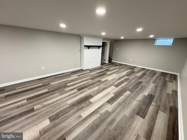 basement with dark hardwood / wood-style flooring