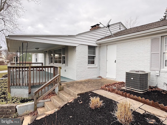 exterior space with central AC unit and a porch