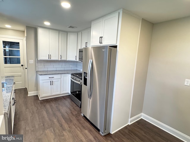 kitchen with white cabinets, decorative backsplash, light stone countertops, dark hardwood / wood-style flooring, and stainless steel appliances