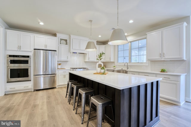 kitchen featuring appliances with stainless steel finishes and white cabinetry