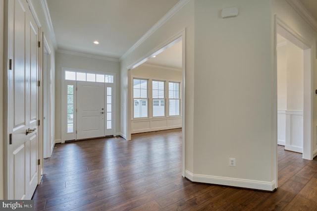 foyer entrance with plenty of natural light, dark hardwood / wood-style floors, and crown molding