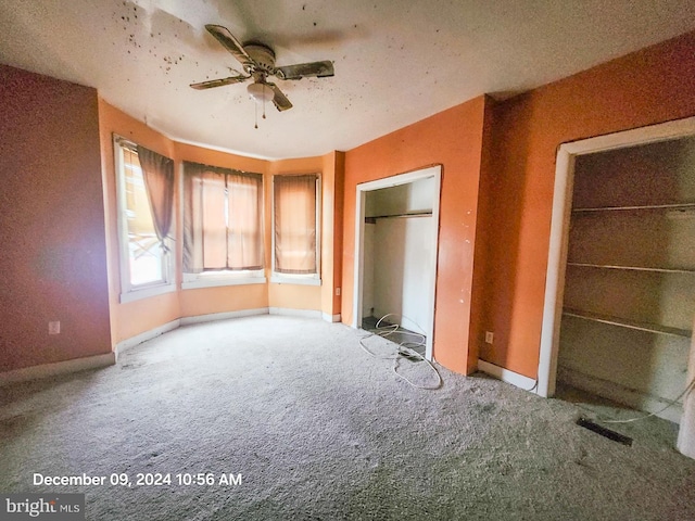 unfurnished bedroom featuring carpet flooring and ceiling fan