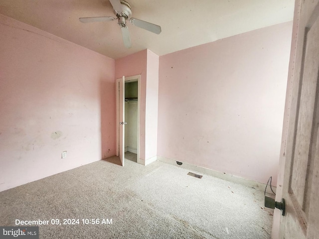 unfurnished room with ceiling fan and light carpet