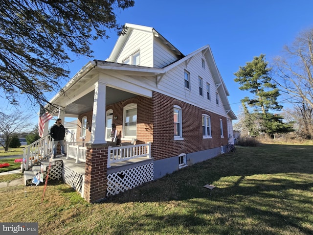 view of property exterior featuring a yard and covered porch