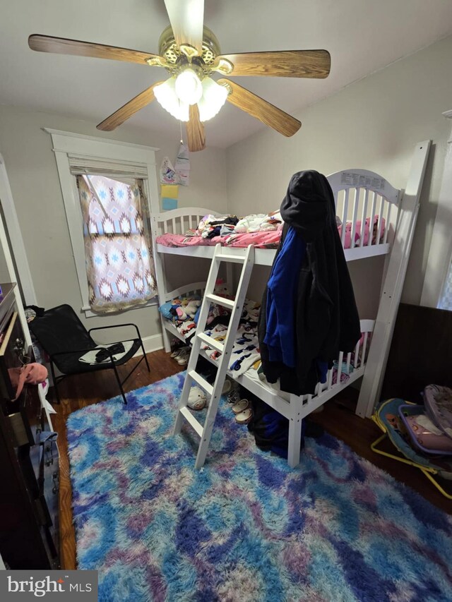 bedroom with ceiling fan and dark hardwood / wood-style floors