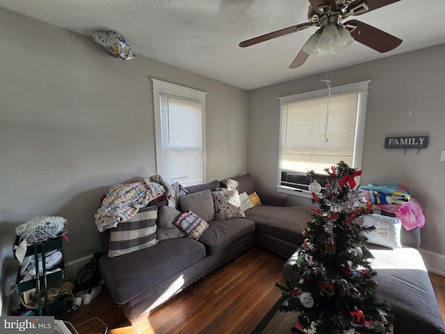 living room with ceiling fan and dark wood-type flooring