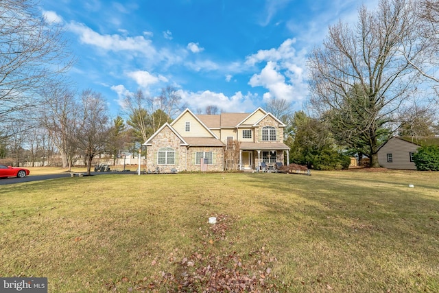 view of front of home with covered porch and a front yard