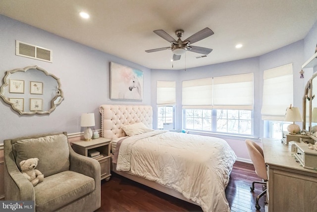 bedroom with dark hardwood / wood-style flooring and ceiling fan