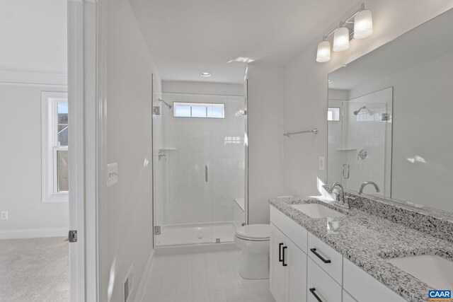 bathroom featuring tile patterned floors, vanity, toilet, and walk in shower