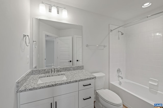 full bathroom with vanity, toilet, and tiled shower / bath combo