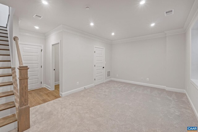 empty room with light colored carpet and ornamental molding