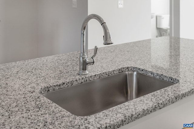 interior details with light stone counters and sink