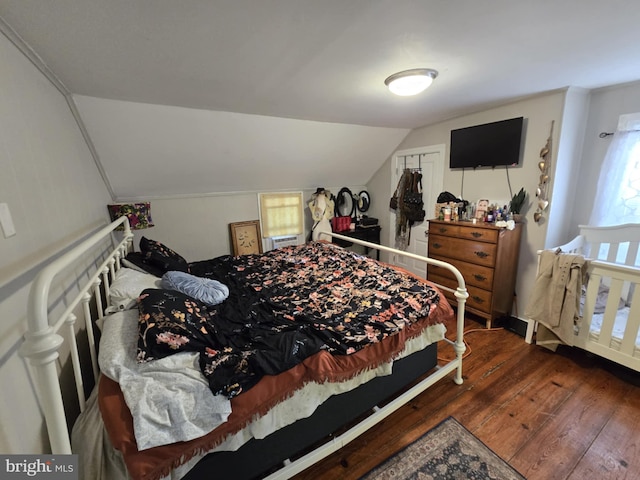 bedroom featuring lofted ceiling and dark wood-type flooring