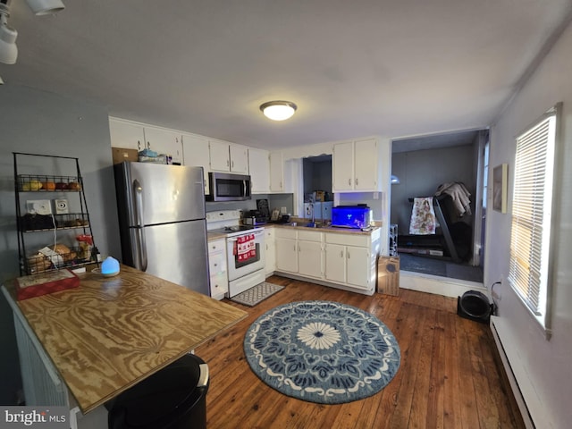 kitchen featuring sink, stainless steel appliances, dark hardwood / wood-style floors, a baseboard heating unit, and white cabinets