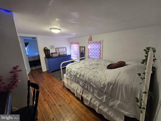 bedroom with dark hardwood / wood-style floors